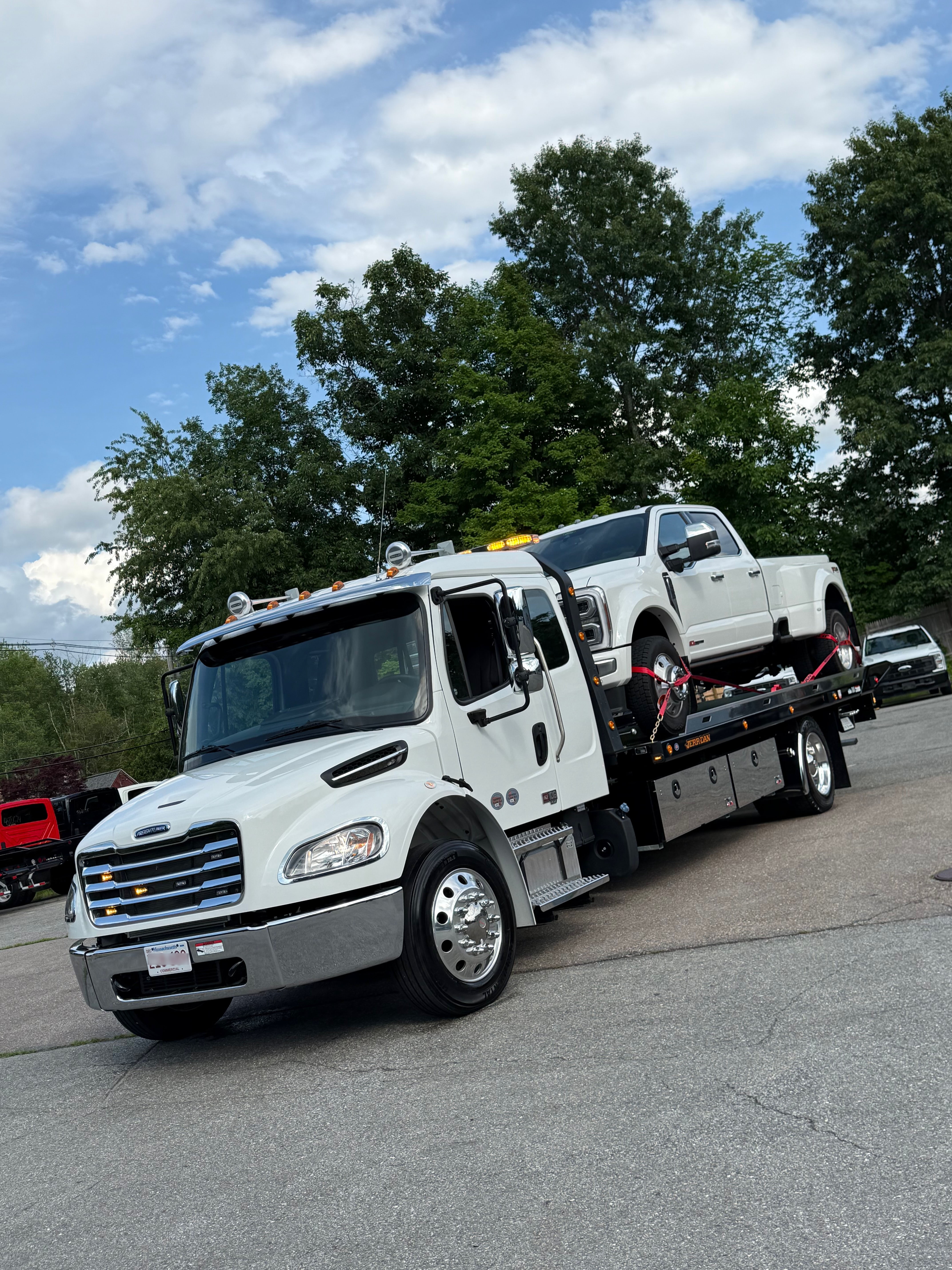 MUSE Towing flatbed hauling a pickup truck